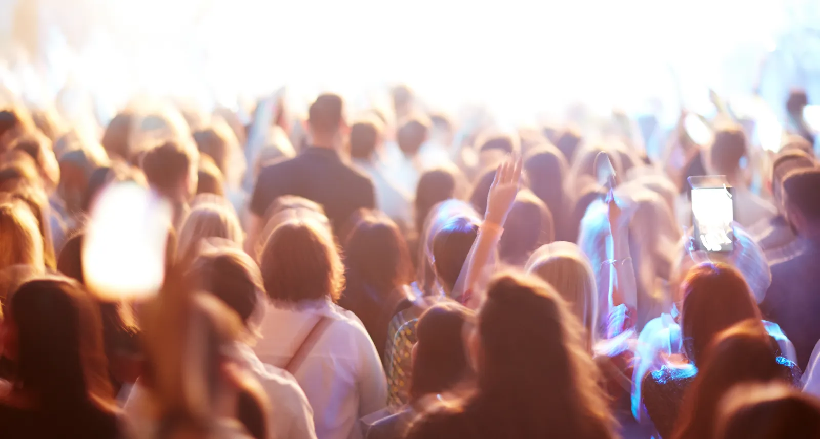 Foule rassemblée devant une scène éclairée